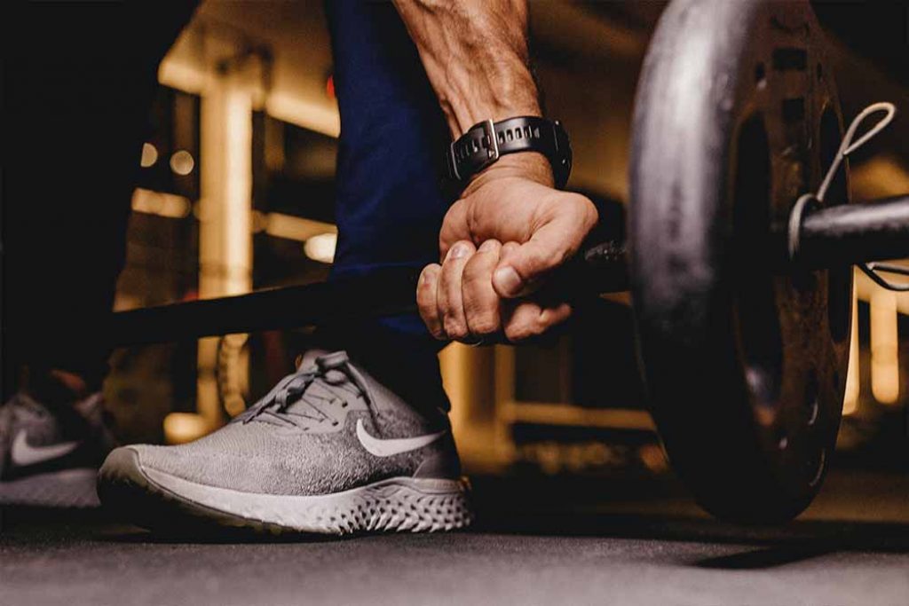 lifting weights fitness male closeup arm