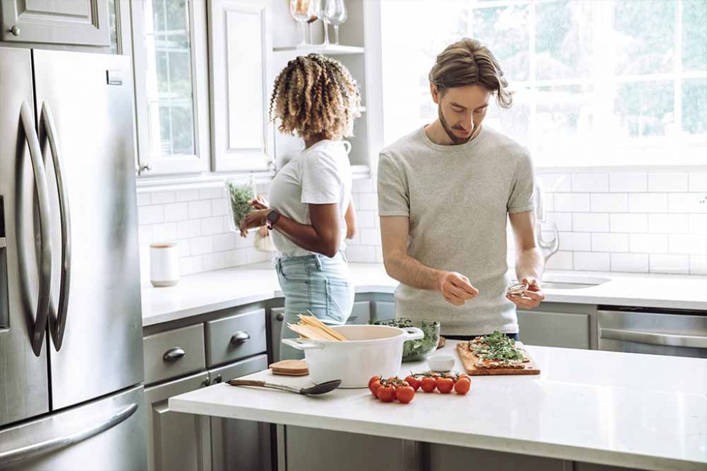 healthy couple making dinner