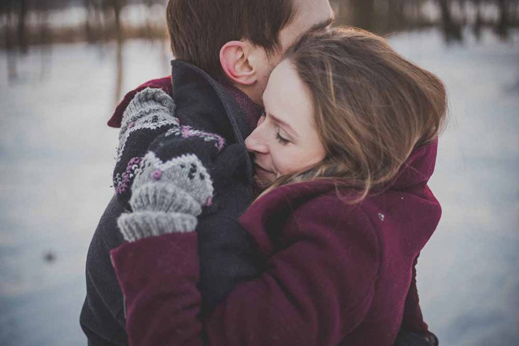 happ couple hug outdoors winter