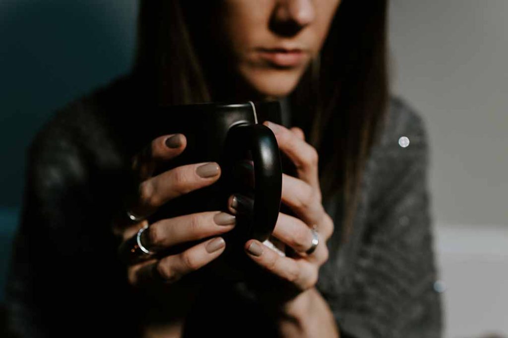 unhappy lady holding a mug