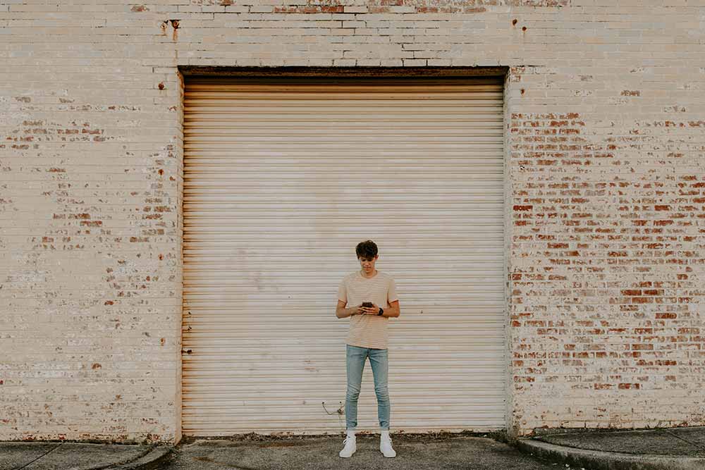 man checking phone for std results